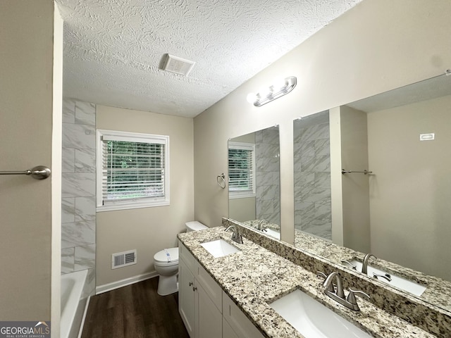 3403 Linda Dr, Lithia Springs, GA 30122 - full bath featuring wood finished floors, double vanity, and a textured ceiling
