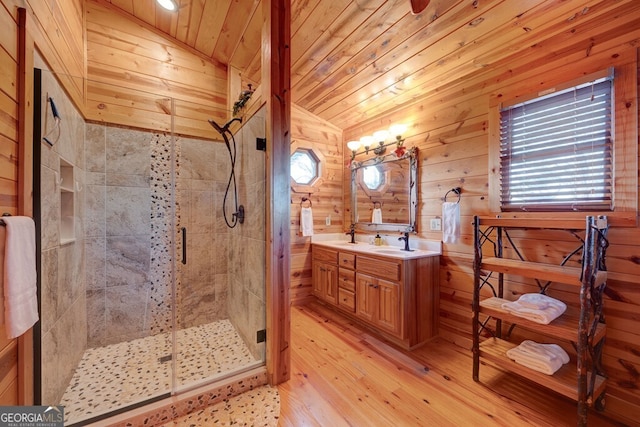 588 Tower Rd, Mineral Bluff, GA 30559 - bathroom featuring vanity, a stall shower, hardwood / wood-style floors, wood walls, and vaulted ceiling