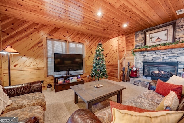 588 Tower Rd, Mineral Bluff, GA 30559 - carpeted living area featuring wood ceiling, wood walls, stairs, and a stone fireplace