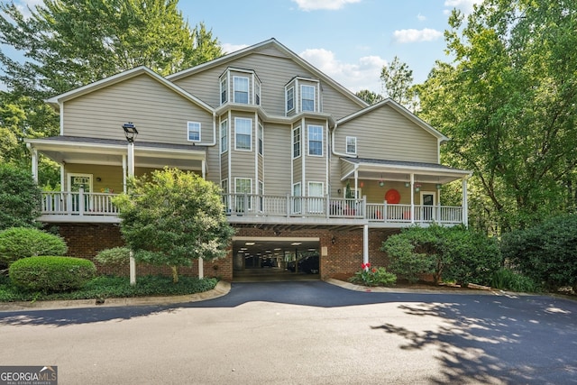 4467 Pineridge Cir, Atlanta, GA 30338 - view of front of house with driveway, a carport, brick siding, and a porch