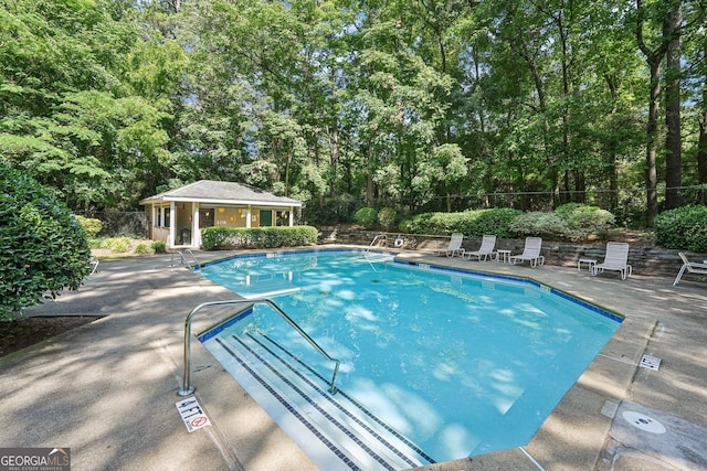 4467 Pineridge Cir, Atlanta, GA 30338 - community pool with a patio area, an outbuilding, and a storage structure