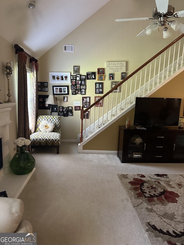 7946 Gossamer Dr, Fairburn, GA 30213 - carpeted living room with stairway, ceiling fan, and vaulted ceiling