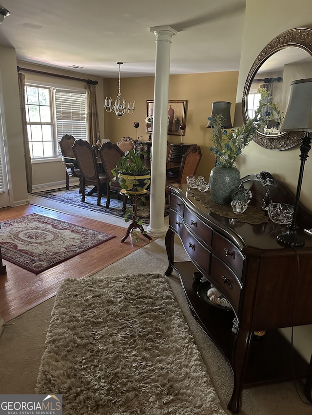7946 Gossamer Dr, Fairburn, GA 30213 - foyer featuring ornate columns, wood finished floors, and a chandelier