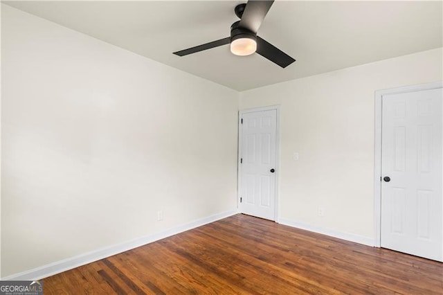 821 Springvalley Dr, Forest Park, GA 30297 - unfurnished bedroom with dark wood-style floors and a ceiling fan