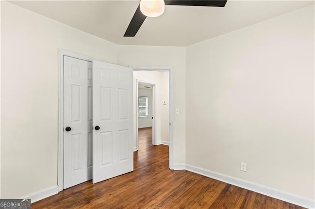 821 Springvalley Dr, Forest Park, GA 30297 - unfurnished bedroom featuring wood finished floors, a closet, and a ceiling fan