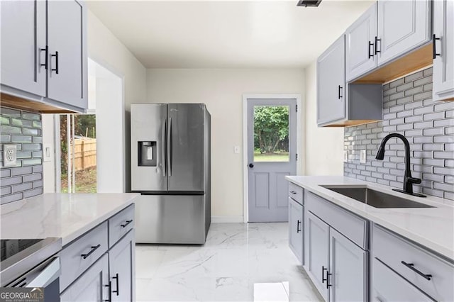821 Springvalley Dr, Forest Park, GA 30297 - kitchen with stainless steel fridge with ice dispenser, tasteful backsplash, light marble finish flooring, and light stone countertops