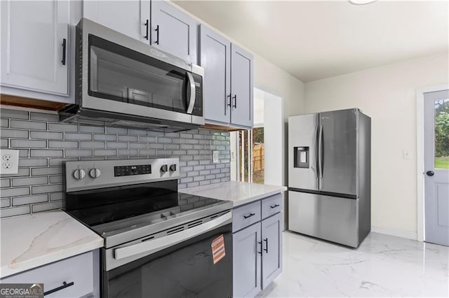 821 Springvalley Dr, Forest Park, GA 30297 - kitchen with stainless steel appliances, light marble finish flooring, light stone counters, and tasteful backsplash