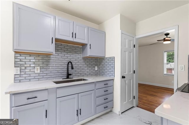 821 Springvalley Dr, Forest Park, GA 30297 - kitchen with tasteful backsplash, ceiling fan, light marble finish flooring, and light stone counters