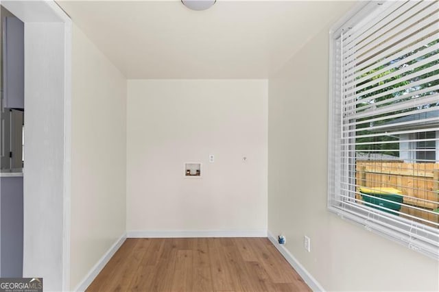 821 Springvalley Dr, Forest Park, GA 30297 - laundry room with wood finished floors and baseboards