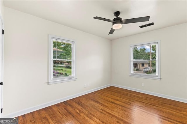 821 Springvalley Dr, Forest Park, GA 30297 - spare room with healthy amount of natural light, wood finished floors, and a ceiling fan