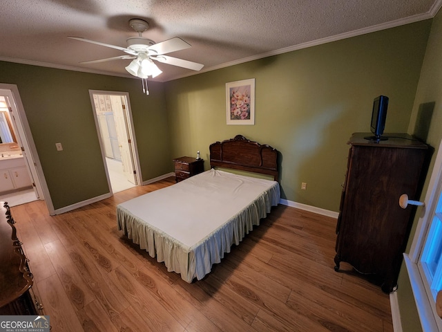 3054 Whisper Knob Rd, Marietta, GA 30062 - bedroom featuring light wood finished floors, crown molding, a textured ceiling, ensuite bath, and a ceiling fan