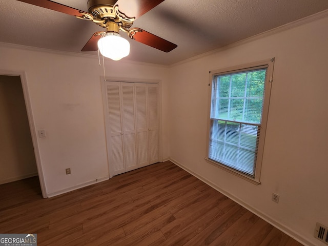 3054 Whisper Knob Rd, Marietta, GA 30062 - spare room featuring crown molding, ceiling fan, wood finished floors, and a textured ceiling