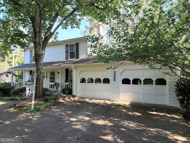 3054 Whisper Knob Rd, Marietta, GA 30062 - view of front facade featuring driveway, a porch, and a chimney