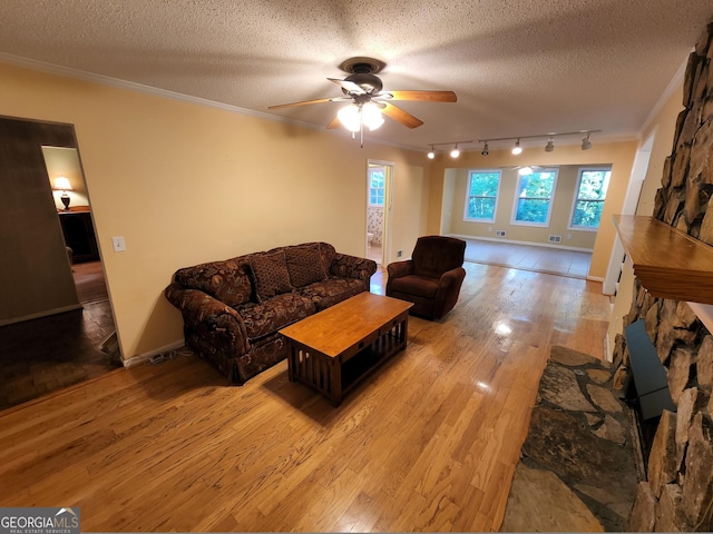 3054 Whisper Knob Rd, Marietta, GA 30062 - living room featuring light wood finished floors, a ceiling fan, crown molding, rail lighting, and a textured ceiling