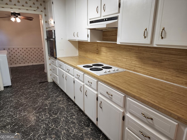 3054 Whisper Knob Rd, Marietta, GA 30062 - kitchen with white electric stovetop, wall oven, under cabinet range hood, ceiling fan, and white cabinets