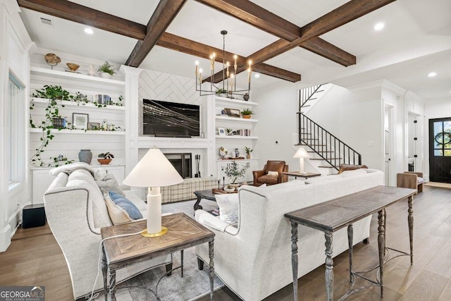 2381 Jones Phillips Rd, Dacula, GA 30019 - living room featuring coffered ceiling, a fireplace, wood finished floors, beam ceiling, and stairway