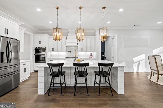 2381 Jones Phillips Rd, Dacula, GA 30019 - kitchen with stainless steel refrigerator with ice dispenser, a chandelier, premium range hood, crown molding, and a kitchen island with sink