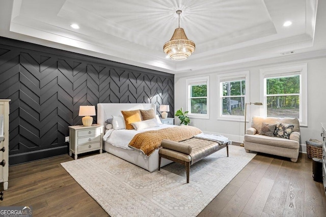 2381 Jones Phillips Rd, Dacula, GA 30019 - bedroom with a raised ceiling, dark wood-style flooring, recessed lighting, a chandelier, and an accent wall