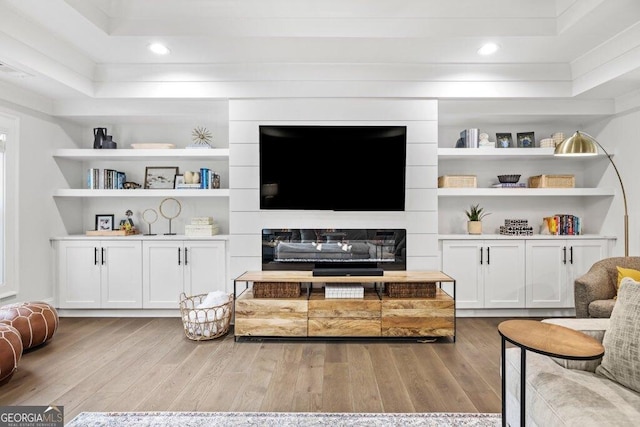 2381 Jones Phillips Rd, Dacula, GA 30019 - living area with wood finished floors, built in shelves, and recessed lighting