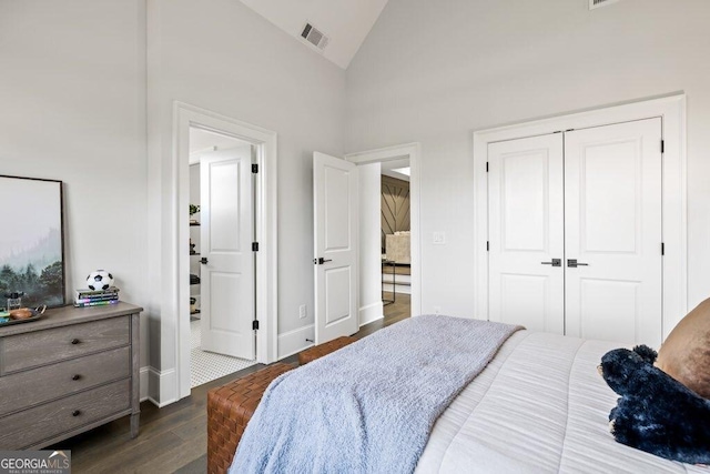 2381 Jones Phillips Rd, Dacula, GA 30019 - bedroom with dark wood-style floors, high vaulted ceiling, and a closet