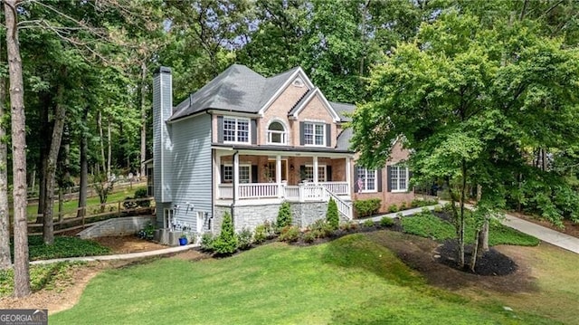 5301 Regency Lake Ct, Sugar Hill, GA 30518 - view of front facade with a porch, a chimney, stairs, and a front yard