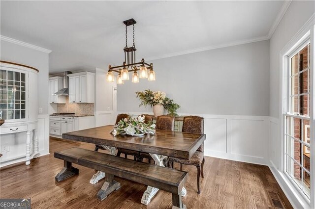 5301 Regency Lake Ct, Sugar Hill, GA 30518 - dining room featuring crown molding, wood finished floors, and wainscoting