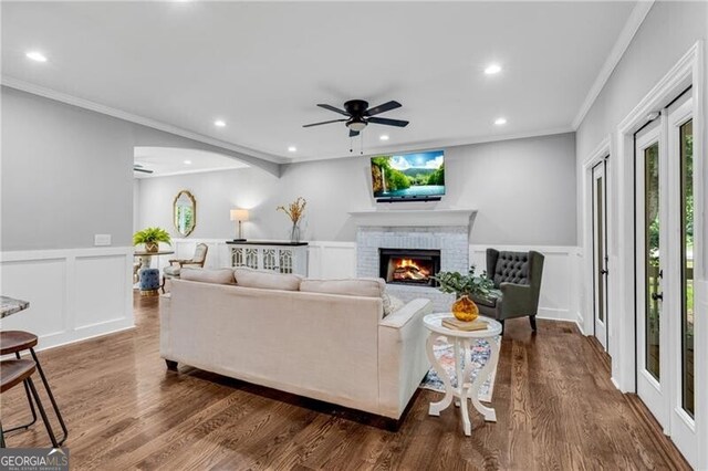5301 Regency Lake Ct, Sugar Hill, GA 30518 - living area featuring a ceiling fan, a decorative wall, crown molding, recessed lighting, and a fireplace