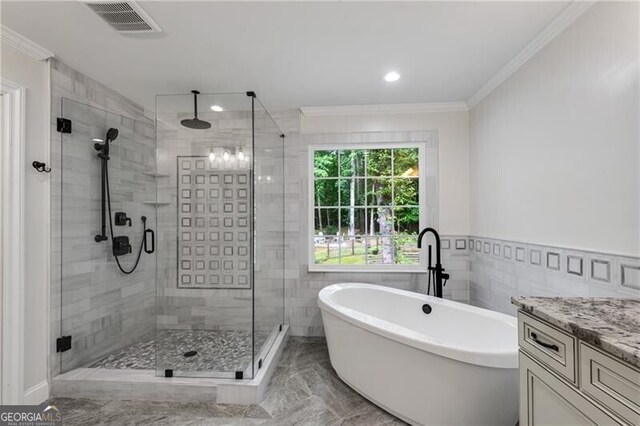 5301 Regency Lake Ct, Sugar Hill, GA 30518 - bathroom with crown molding, a freestanding tub, two vanities, a shower stall, and marble finish flooring