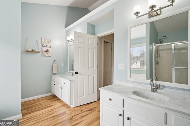 5686 Grindstone Dr, Buford, GA 30518 - full bath featuring two vanities, wood finished floors, a stall shower, and lofted ceiling
