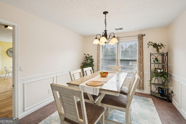 5686 Grindstone Dr, Buford, GA 30518 - carpeted dining room with a chandelier, wainscoting, and a decorative wall