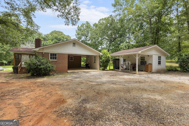 8692 Estes Rd, Macon, GA 31220 - view of front of house featuring a chimney, dirt driveway, and brick siding