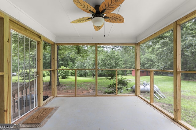 8692 Estes Rd, Macon, GA 31220 - unfurnished sunroom featuring a ceiling fan and view of scattered trees