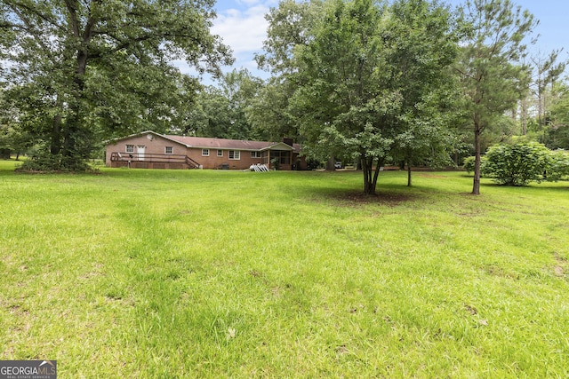 8692 Estes Rd, Macon, GA 31220 - view of grassy yard with a deck