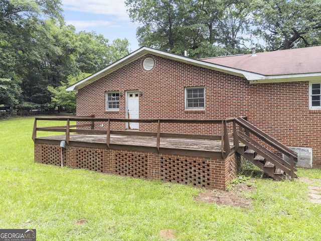 8692 Estes Rd, Macon, GA 31220 - back of property with a wooden deck, a lawn, and brick siding