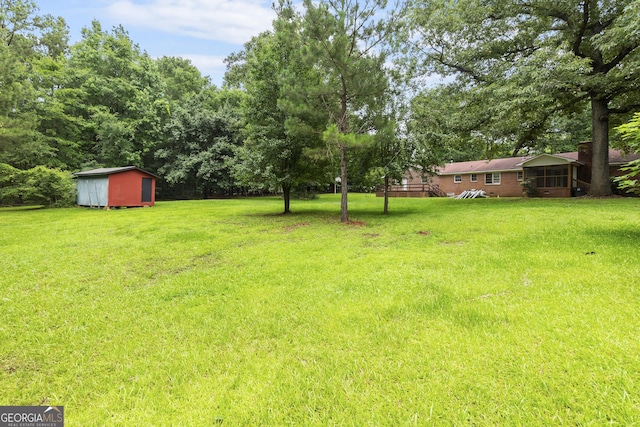8692 Estes Rd, Macon, GA 31220 - view of green lawn featuring a storage unit