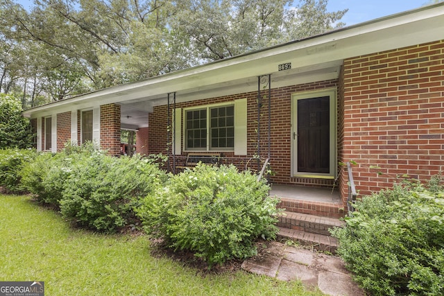 8692 Estes Rd, Macon, GA 31220 - view of exterior entry with brick siding and covered porch