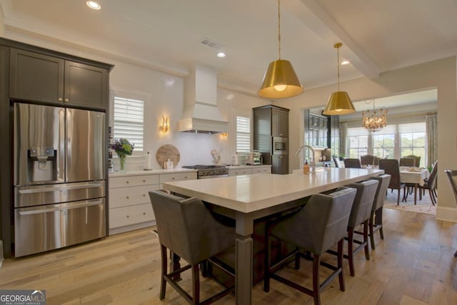 24 Lakewood Park N, Statham, GA 30666 - kitchen with stainless steel appliances, premium range hood, light countertops, light wood-style floors, and recessed lighting