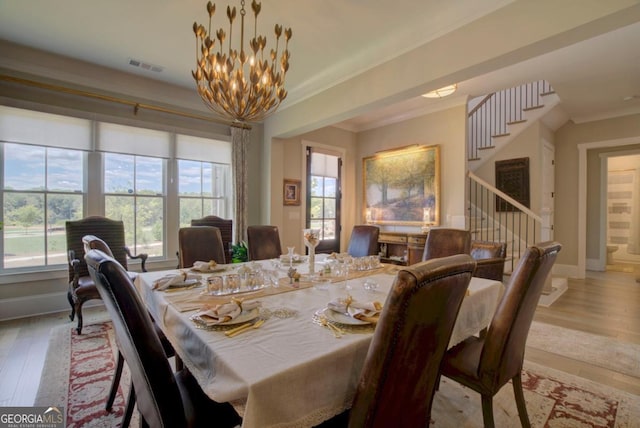 24 Lakewood Park N, Statham, GA 30666 - dining space with stairway, healthy amount of natural light, a chandelier, light wood finished floors, and crown molding