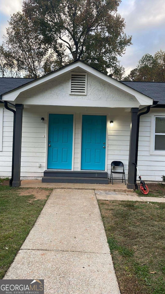 3351 Fox St, Duluth, GA 30096 - doorway to property featuring a porch and a lawn