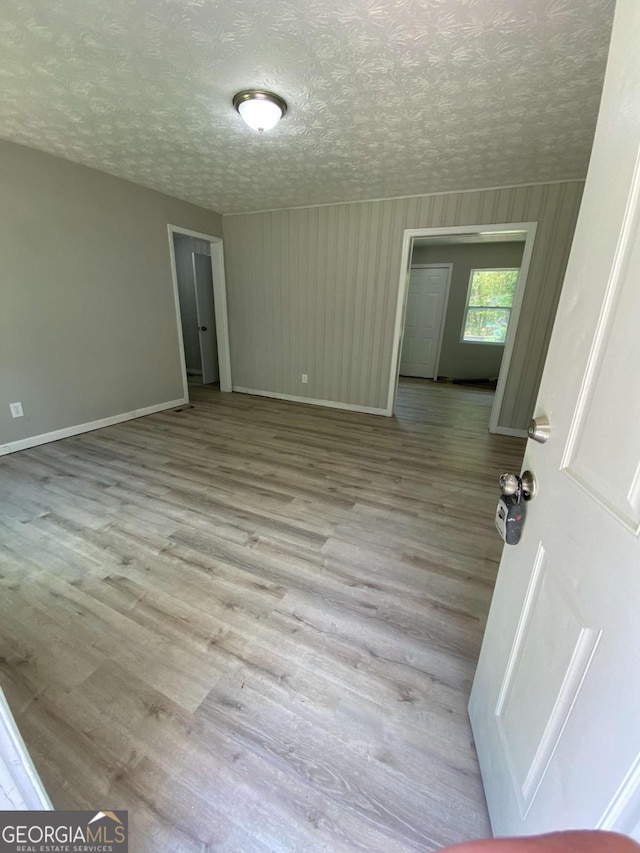 3351 Fox St, Duluth, GA 30096 - empty room featuring wood finished floors and a textured ceiling
