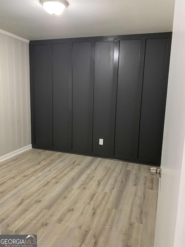 3351 Fox St, Duluth, GA 30096 - spare room featuring wood finished floors and a decorative wall