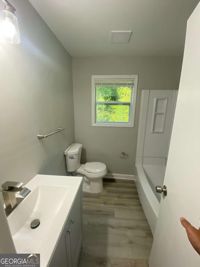 3341 Fox St, Duluth, GA 30096 - full bathroom featuring wood finished floors, vanity, a tub to relax in, and a shower