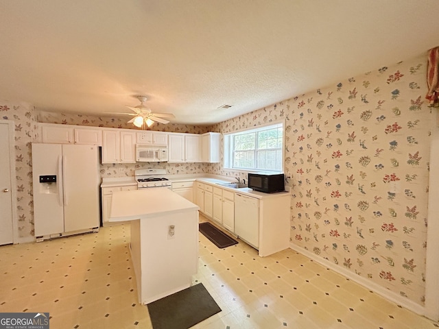 5190 Bankside Way, Peachtree Corners, GA 30092 - kitchen featuring white appliances, wallpapered walls, a kitchen island, a ceiling fan, and light countertops