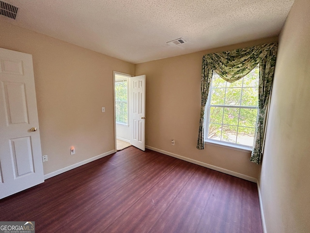 5190 Bankside Way, Peachtree Corners, GA 30092 - spare room with dark wood-type flooring, plenty of natural light, and a textured ceiling