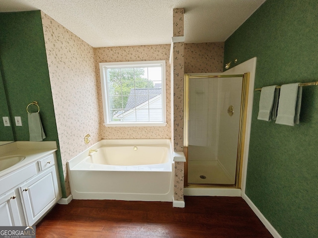 5190 Bankside Way, Peachtree Corners, GA 30092 - bathroom featuring wood finished floors, wallpapered walls, a stall shower, a garden tub, and vanity