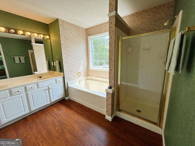5190 Bankside Way, Peachtree Corners, GA 30092 - bathroom with wallpapered walls, wood finished floors, a bath, a stall shower, and double vanity