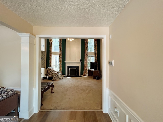 5190 Bankside Way, Peachtree Corners, GA 30092 - corridor featuring healthy amount of natural light, a textured ceiling, wood finished floors, and decorative columns