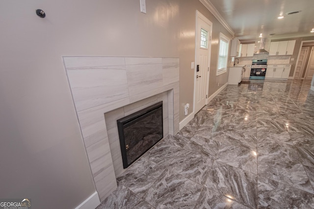 5763 Houston Rd, Macon, GA 31216 - living area with ornamental molding, a tiled fireplace, and marble tiled floors