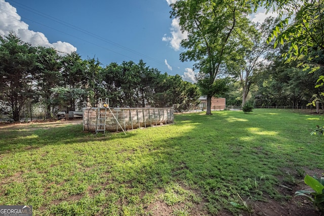 5763 Houston Rd, Macon, GA 31216 - view of grassy yard featuring view of wooded area
