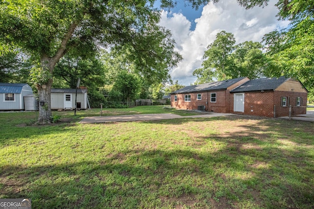 5763 Houston Rd, Macon, GA 31216 - view of yard with a storage unit and a patio area